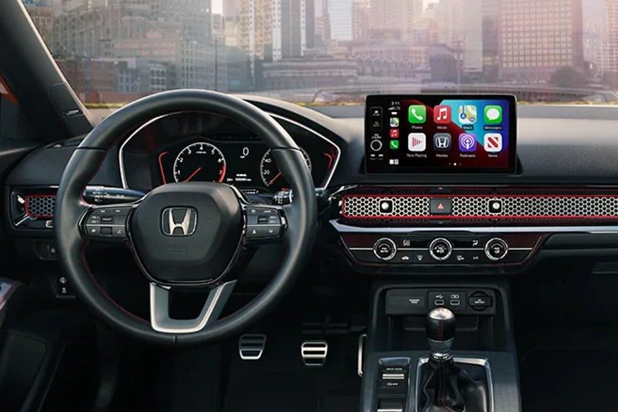 2024 Honda Civic interior showing the clean dashboard design with honeycomb mesh accent and physical climate controls