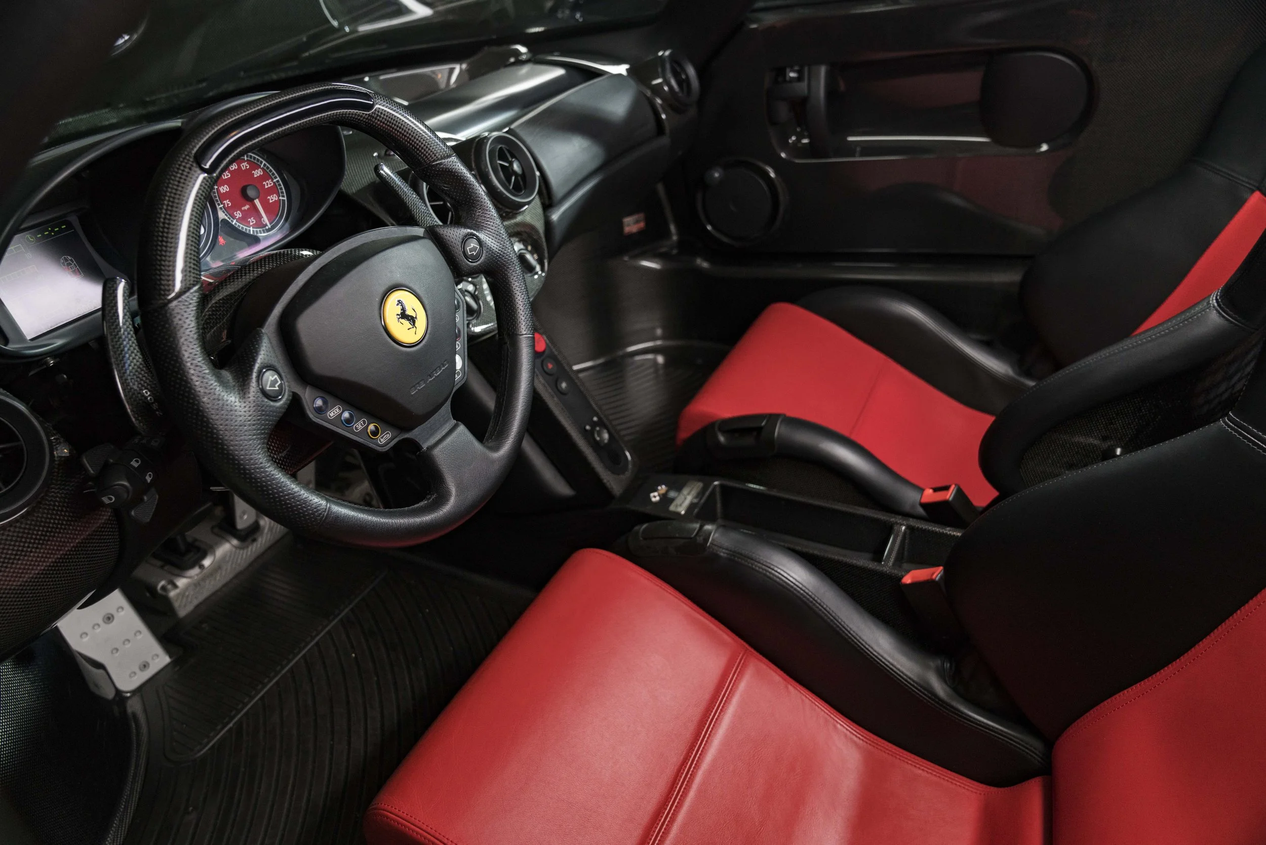 Ferrari Enzo interior showing the minimalist cockpit with exposed carbon fibre and racing-derived controls