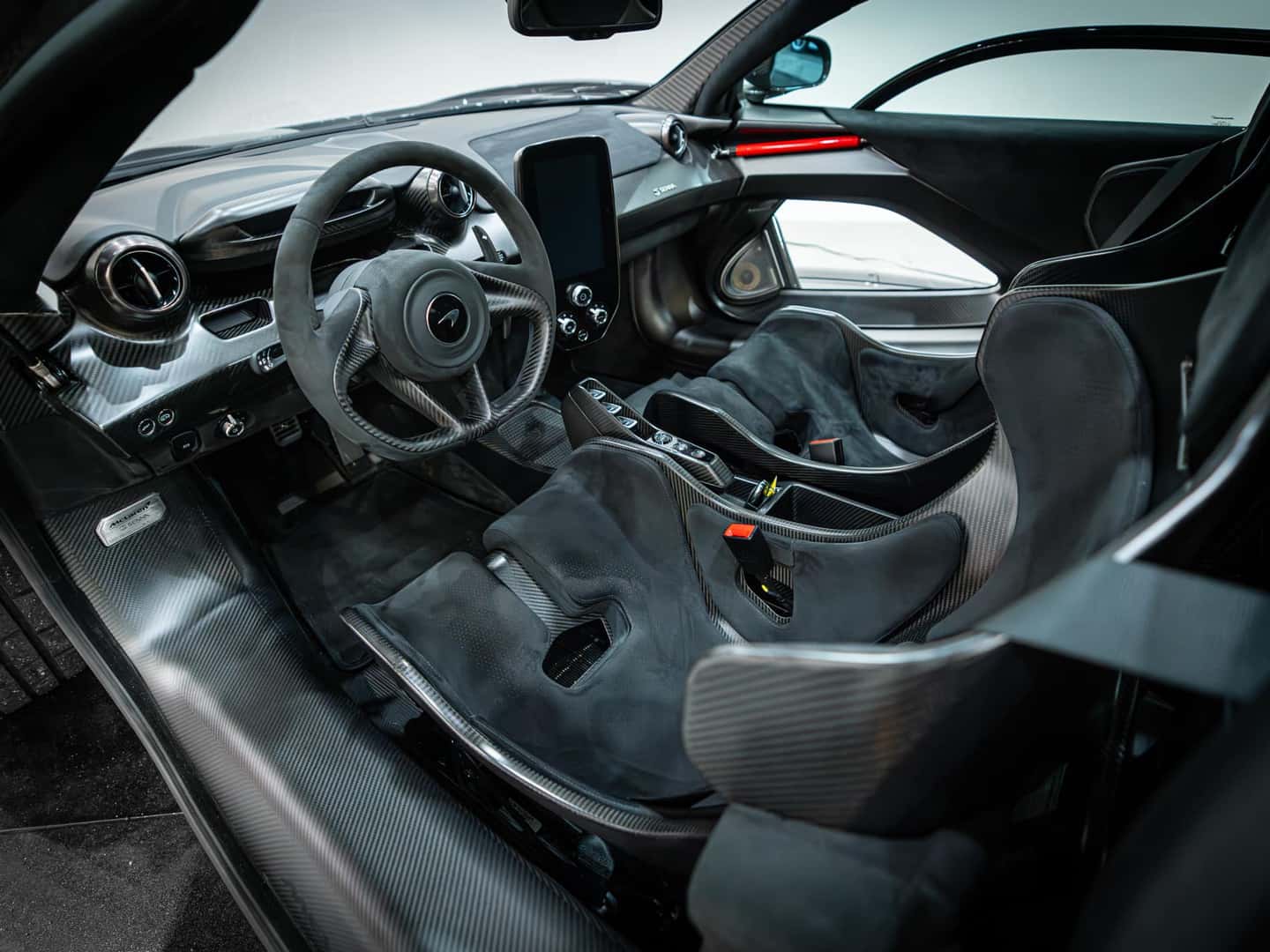 McLaren Senna interior detail showing the carbon fibre monocoque tub and minimalist controls